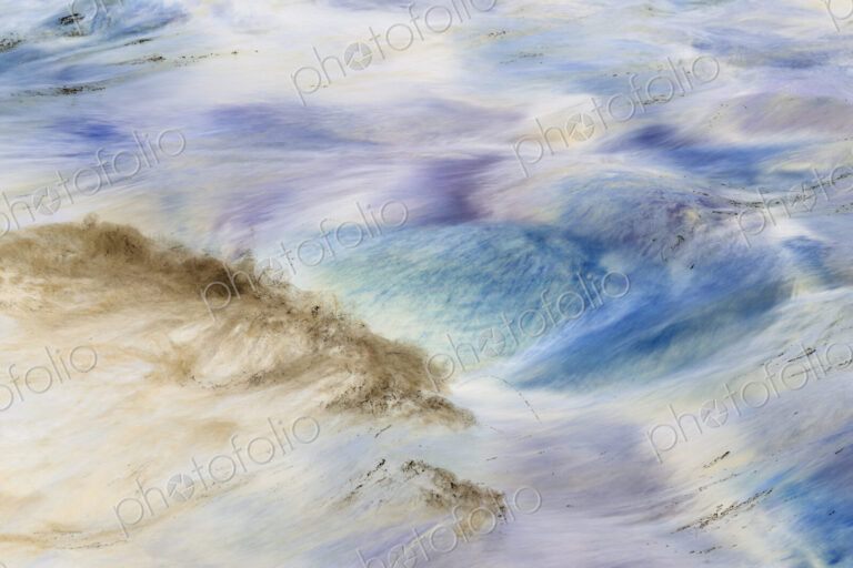 River water abstract, long exposure of river water flowing over boulders and rocks,…