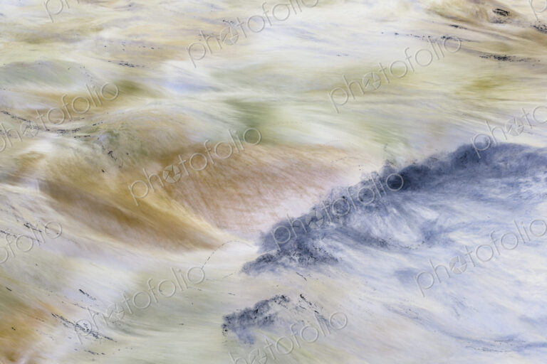 River water abstract, long exposure of river water flowing over boulders and rocks,…