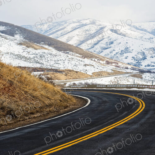 Road Through a Snowy Mountain Landscape Road Through a Snowy Mountain Landscape
