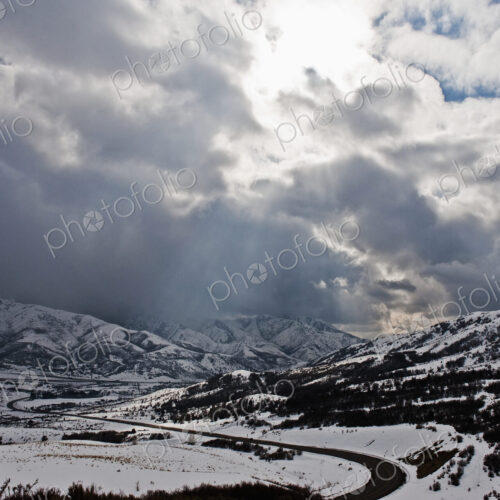 Road Through a Snowy Mountain Landscape Road Through a Snowy Mountain Landscape