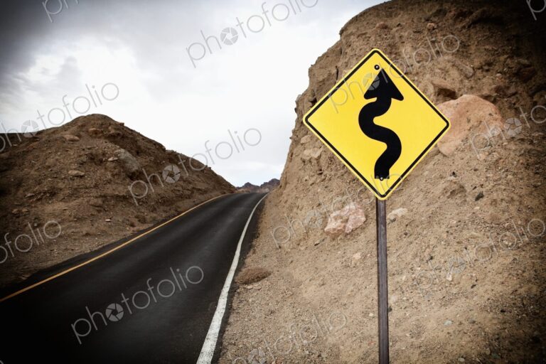 Road and Road Sign showing winding road ahead, Death Valley National Park, Death…