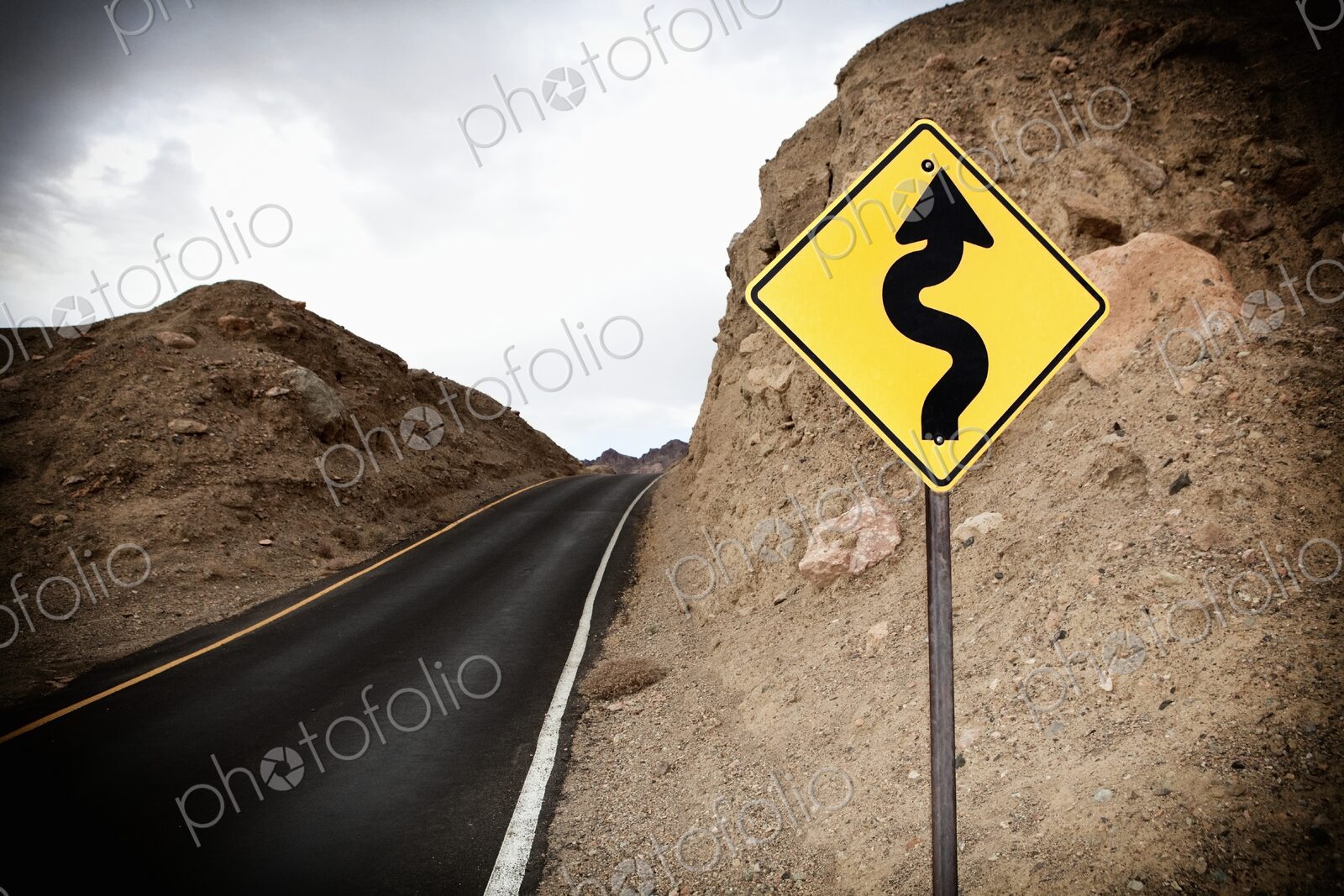 Road and Road Sign showing winding road ahead, Death Valley National Park, Death…