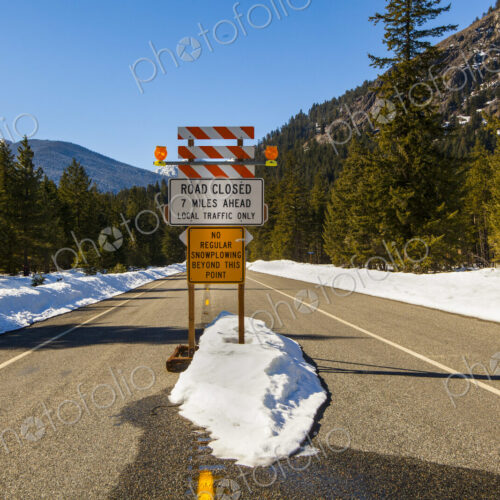 Road closed sign in mountains, North Cascades Highway, winter time, snow drifts. Road closed sign in mountains, North Cascades Highway, winter time, snow drifts.