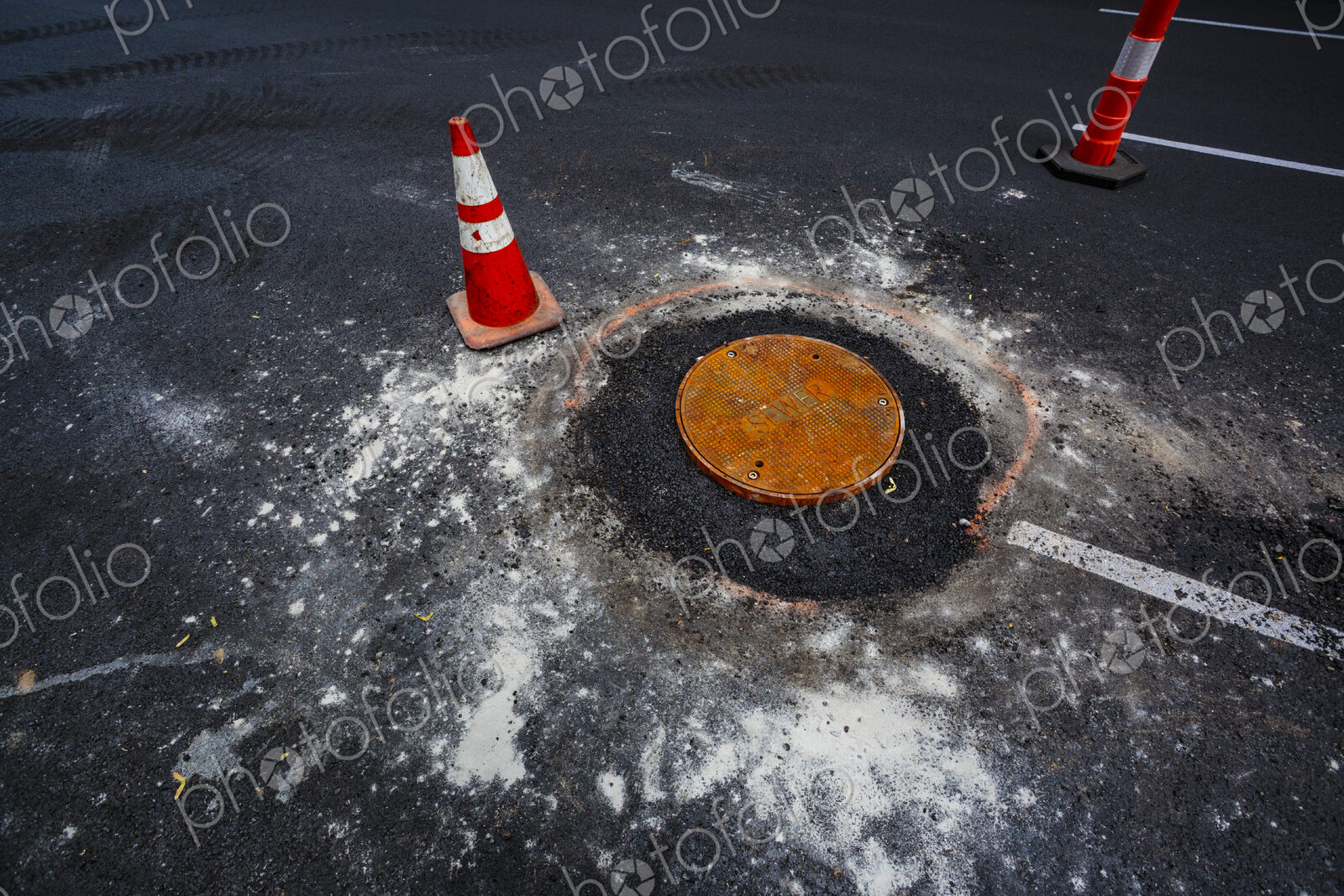 Road construction over sewer manhole cov, WA USA