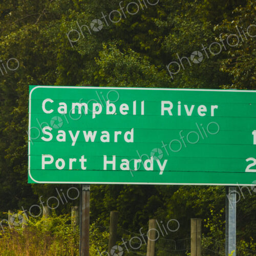 Road sign for Vancouver Island along Highway Highway 1, with mileage information Road sign for Vancouver Island along Highway Highway 1, with mileage information