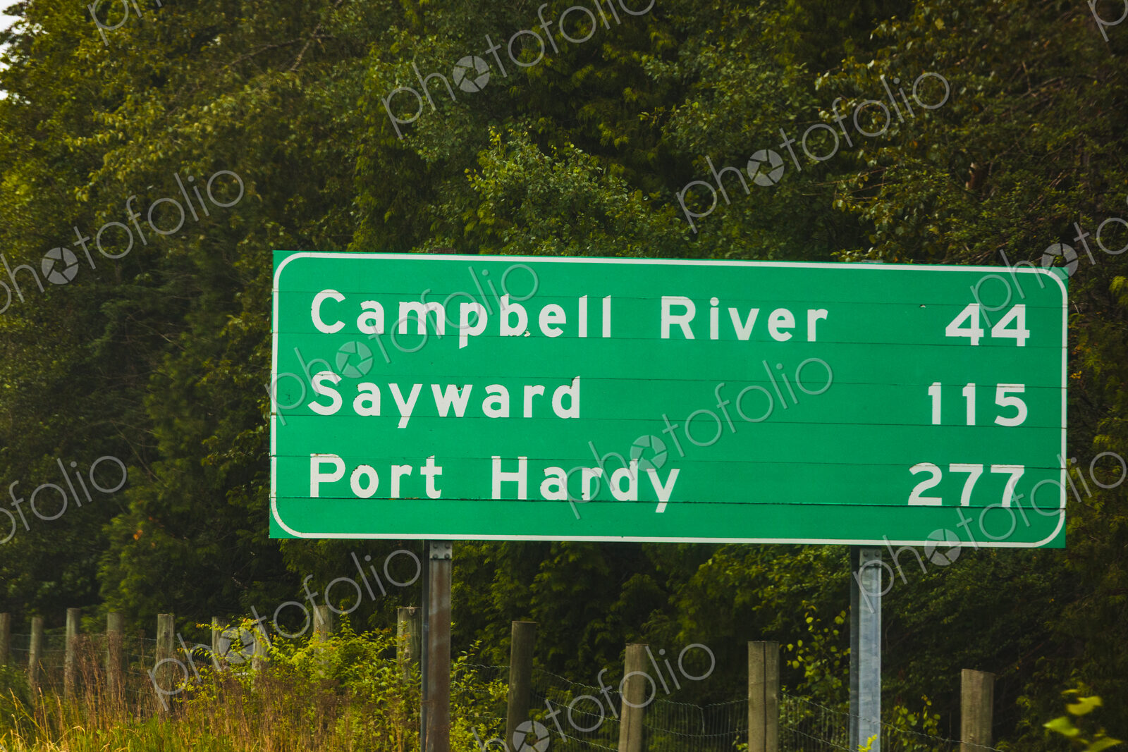 Road sign for Vancouver Island along Highway Highway 1, with mileage information