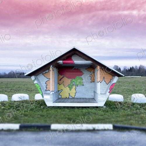 Roadside bus stop in Estonia. Hay baled in white plastic sacks.