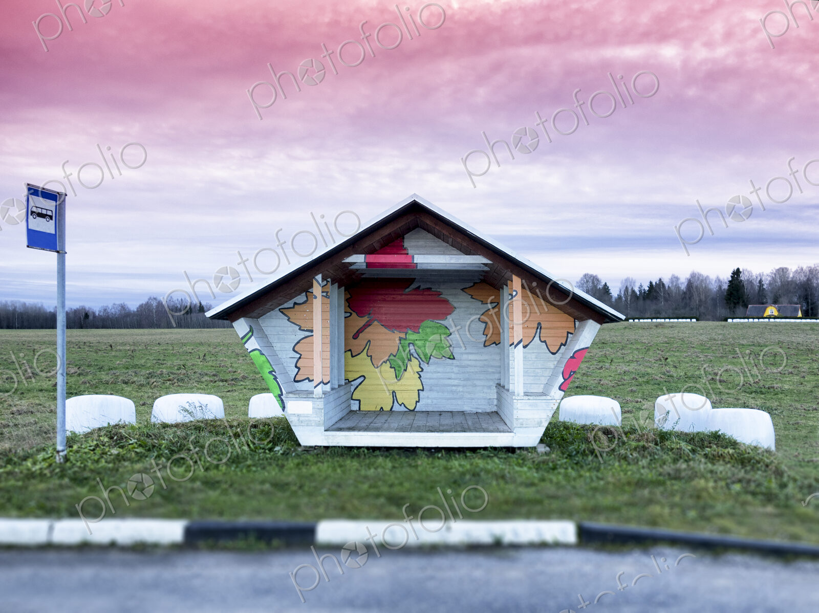 Roadside bus stop in Estonia. Hay baled in white plastic sacks.