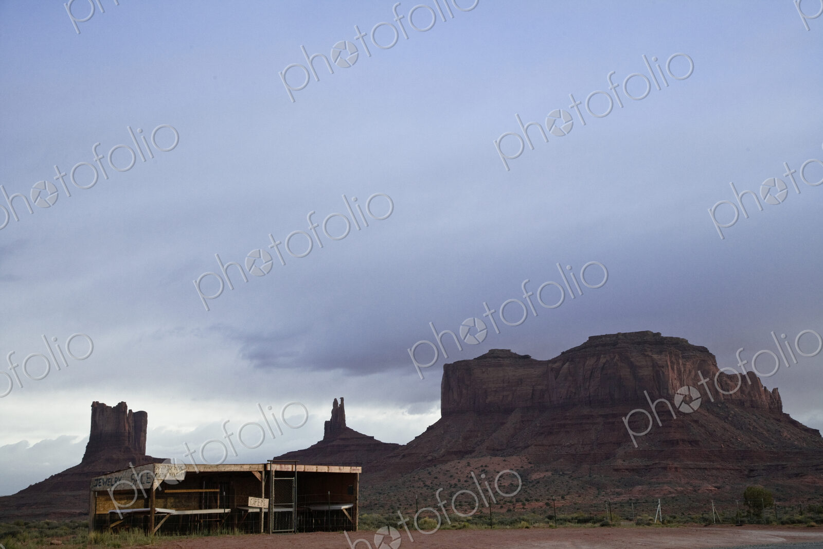 Rock formation in countryside with shed in foreground.