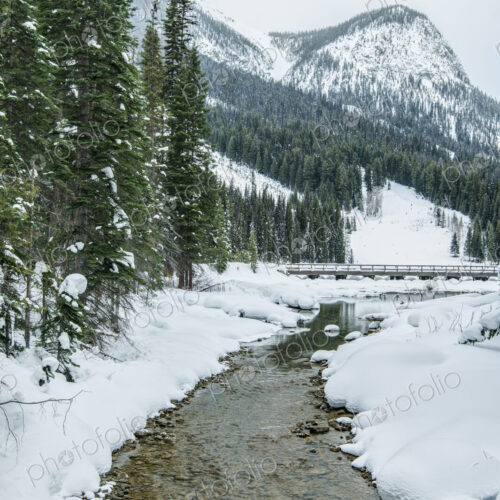 Rocky creek in snowy rural landscape Rocky creek in snowy rural landscape