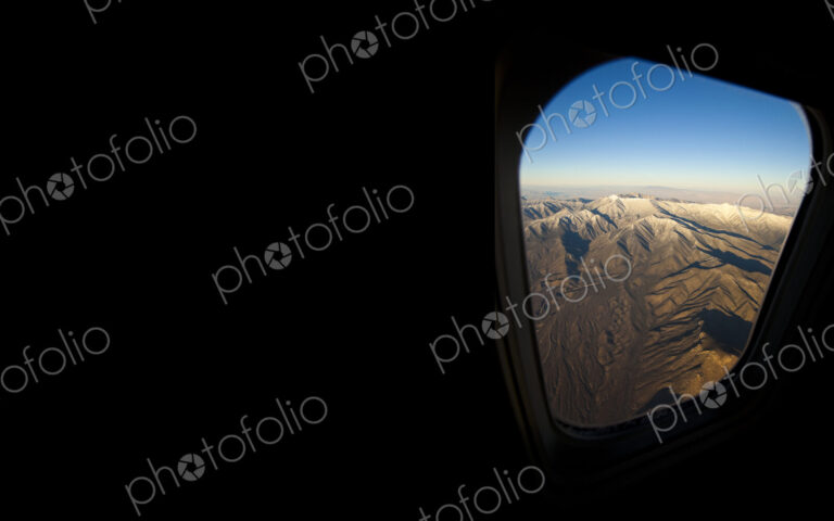Rocky landscape viewed from airplane window