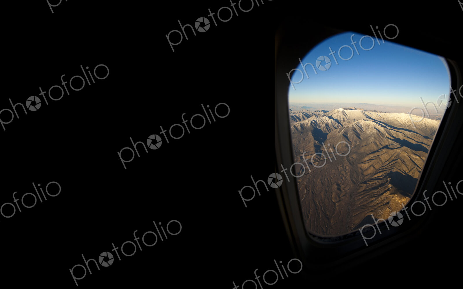 Rocky landscape viewed from airplane window