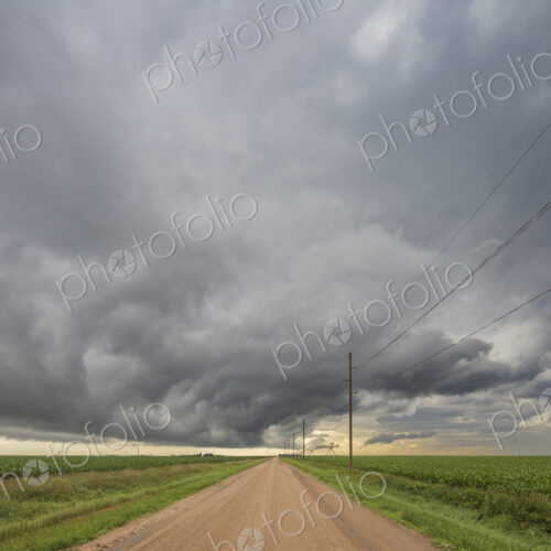 Roll cloud in the sky, a gatheriing storm over a dirt road, reaching to a brighter… Roll cloud in the sky, a gatheriing storm over a dirt road, reaching to a brighter…
