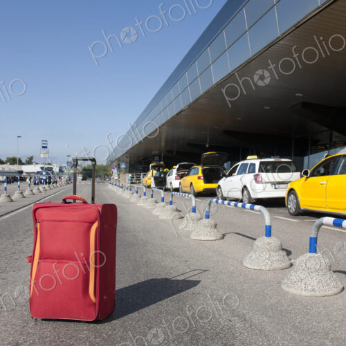 Rolling Luggage Outside an Airport Terminal Rolling Luggage Outside an Airport Terminal