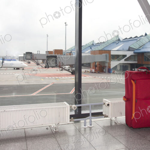 Rolling Luggage in an Airport Concourse Rolling Luggage in an Airport Concourse