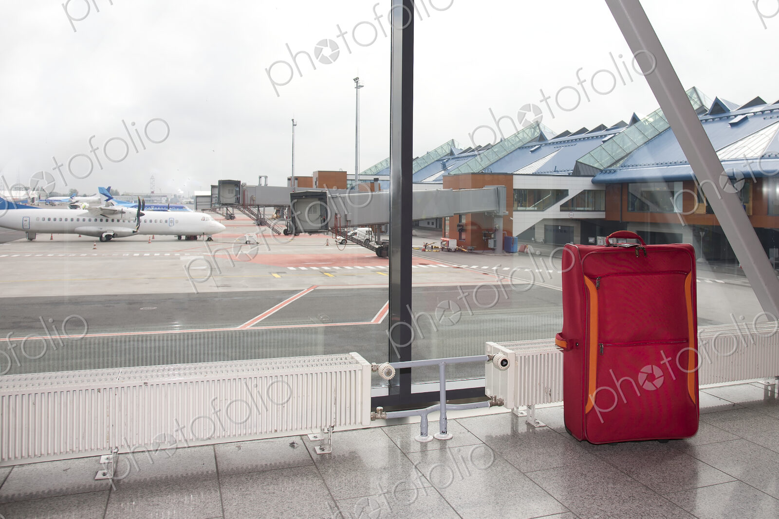 Rolling Luggage in an Airport Concourse