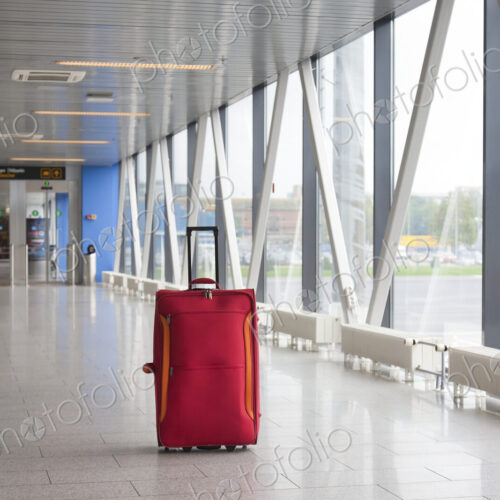 Rolling Luggage in an Airport Concourse Rolling Luggage in an Airport Concourse