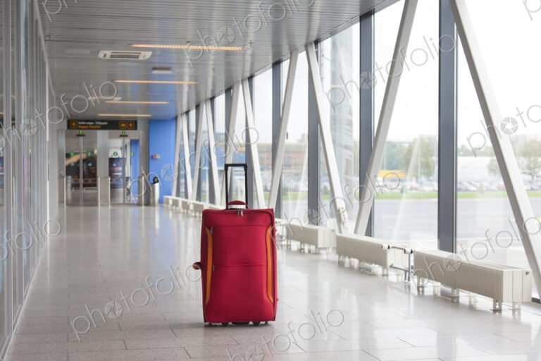 Rolling Luggage in an Airport Concourse