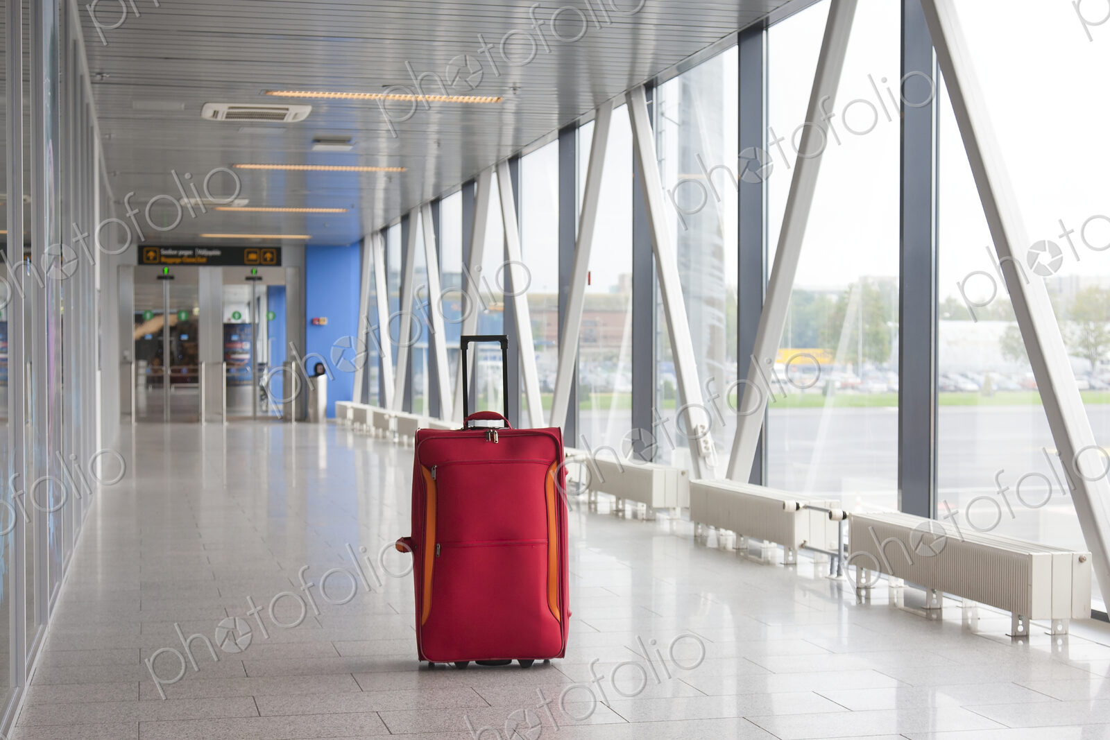 Rolling Luggage in an Airport Concourse