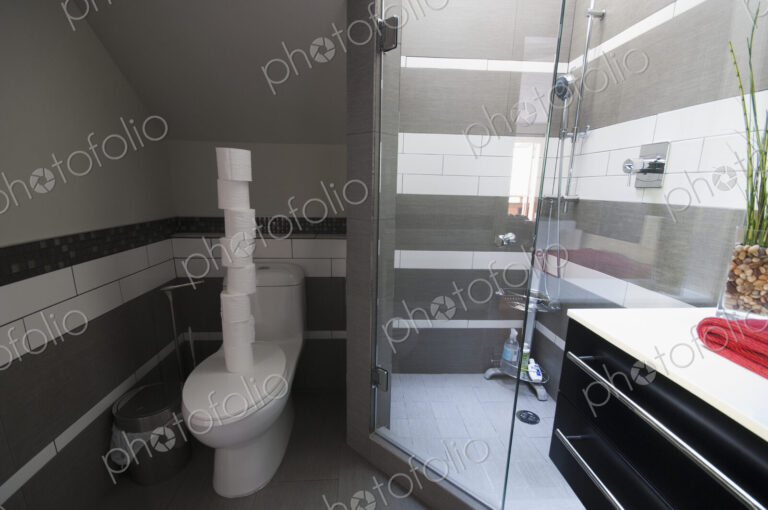 Rolls of Toilet Paper Stacked in a Bathroom