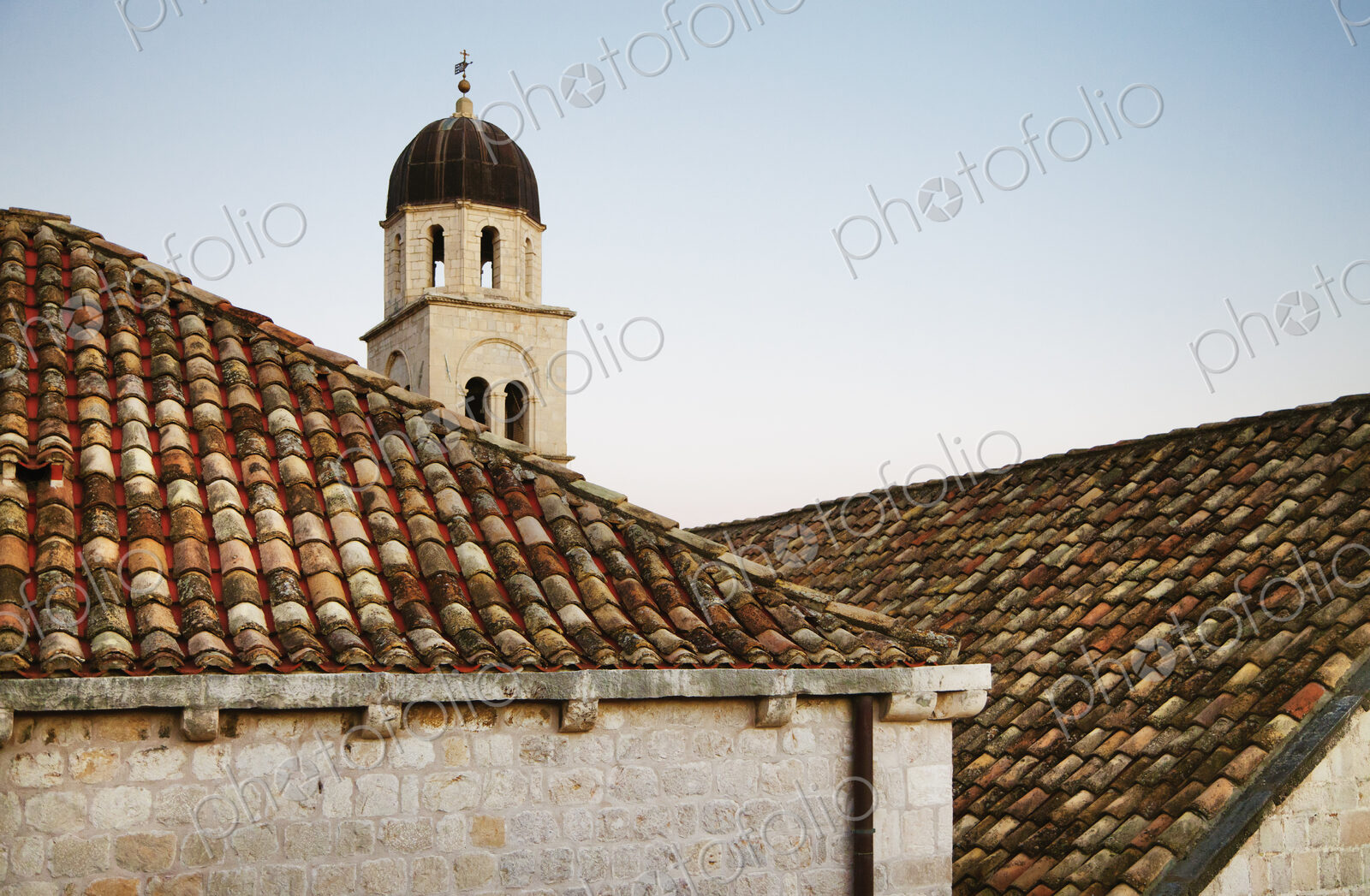 Rooftops and a bell tower at sunset in the old city of Dubrovnik