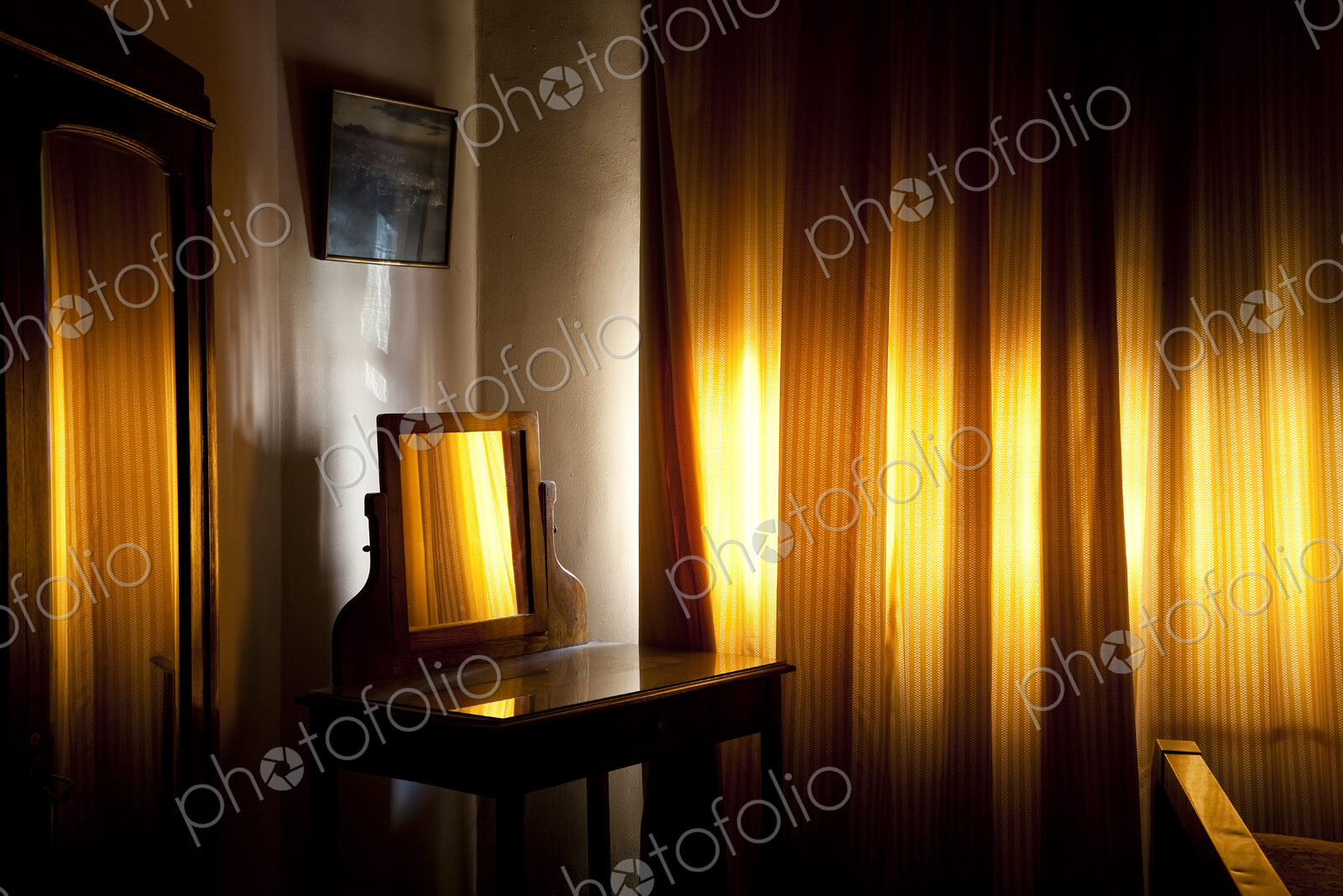 Room interior, vintage wooden dressing table with mirror and drawn curtains
