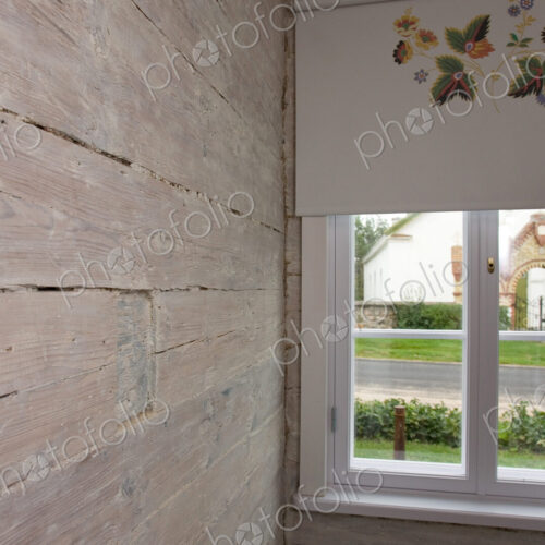 Room with wooden wall and window and patterned window blind. Room with wooden wall and window and patterned window blind.