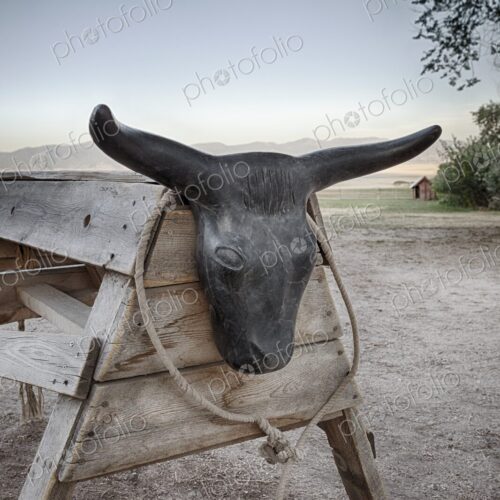 Roping dummy set up on dirt ranch ground, with coiled rope and mountain landscape in… Roping dummy set up on dirt ranch ground, with coiled rope and mountain landscape in…