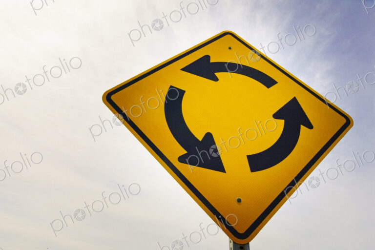 Round-a-bout traffic sign, yellow directional arrows, anticlockwise direction of flow,…