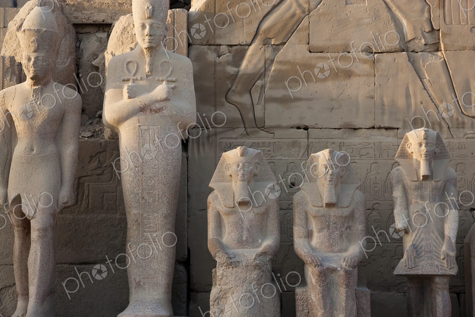 Row of ancient Egyptian stone sculptures of Pharaohs.