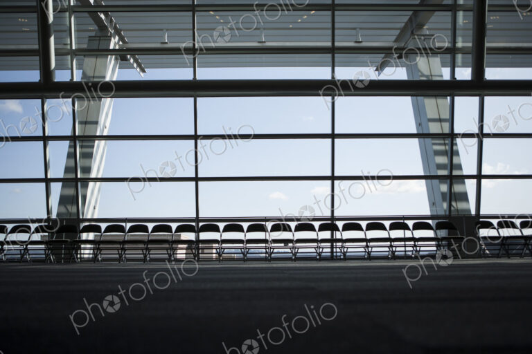 Row of chairs silhouetted against a window in a conference centre.