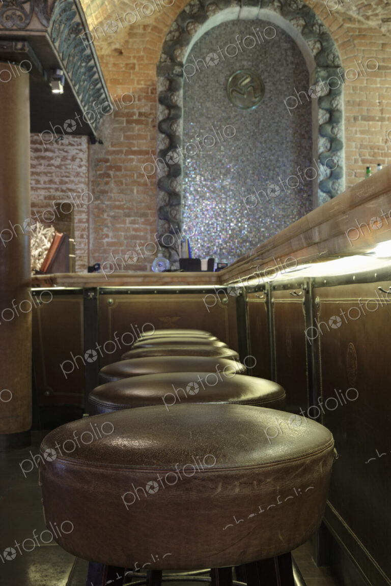 Row of leather seat bar stools in a bar or nightclub