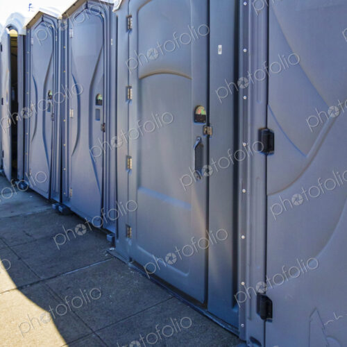 Row of portable restrooms at a reststop area on Route 90 in Washington state. Row of portable restrooms at a reststop area on Route 90 in Washington state.