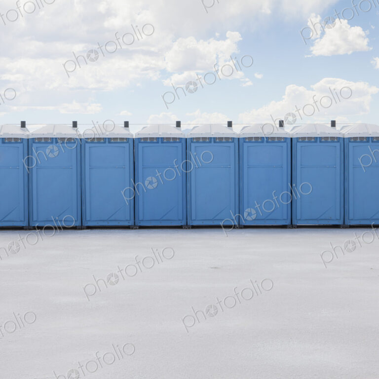 Row of portable toilets on salt flats, during Speed Week