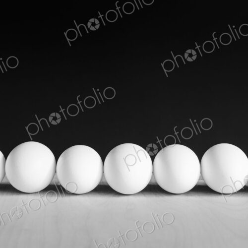 Row of white, free range, organic eggs, black background Row of white, free range, organic eggs, black background
