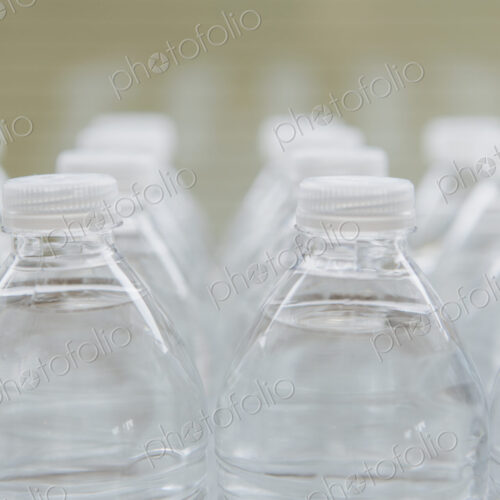 Rows of water-filled plastic bottles with screw caps.