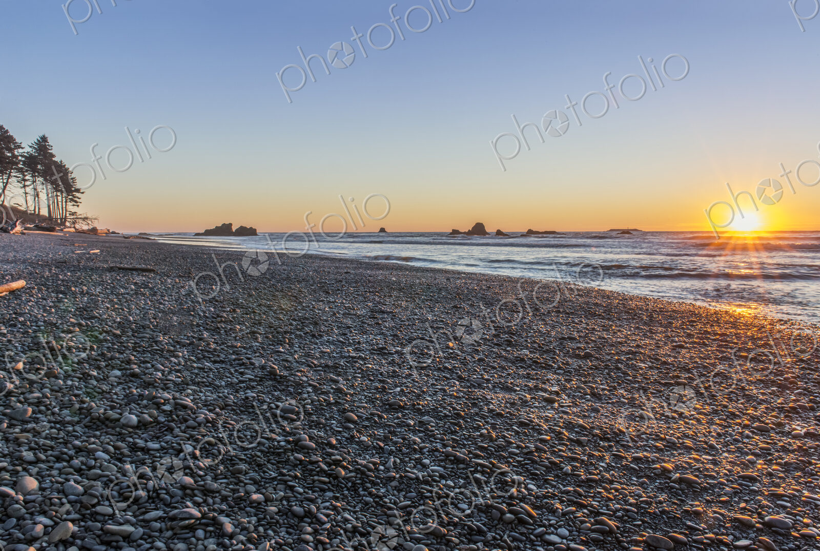 Ruby Beach in Olympic National Park with sun setting over ocean.