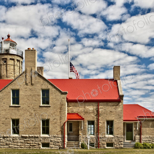 Rustic Lighthouse with a Flag at Half Mast