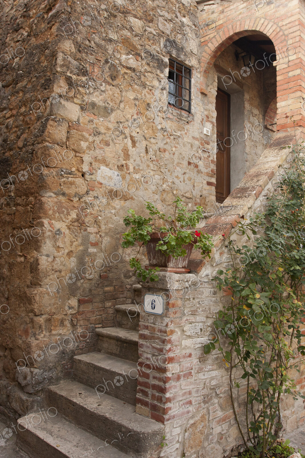 Rustic entryway into a traditional Tuscan home.