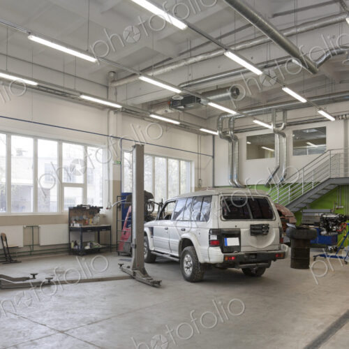SUV in a large repair workshop or garage.