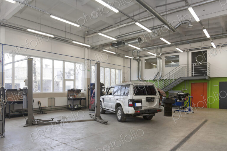 SUV in a large repair workshop or garage.