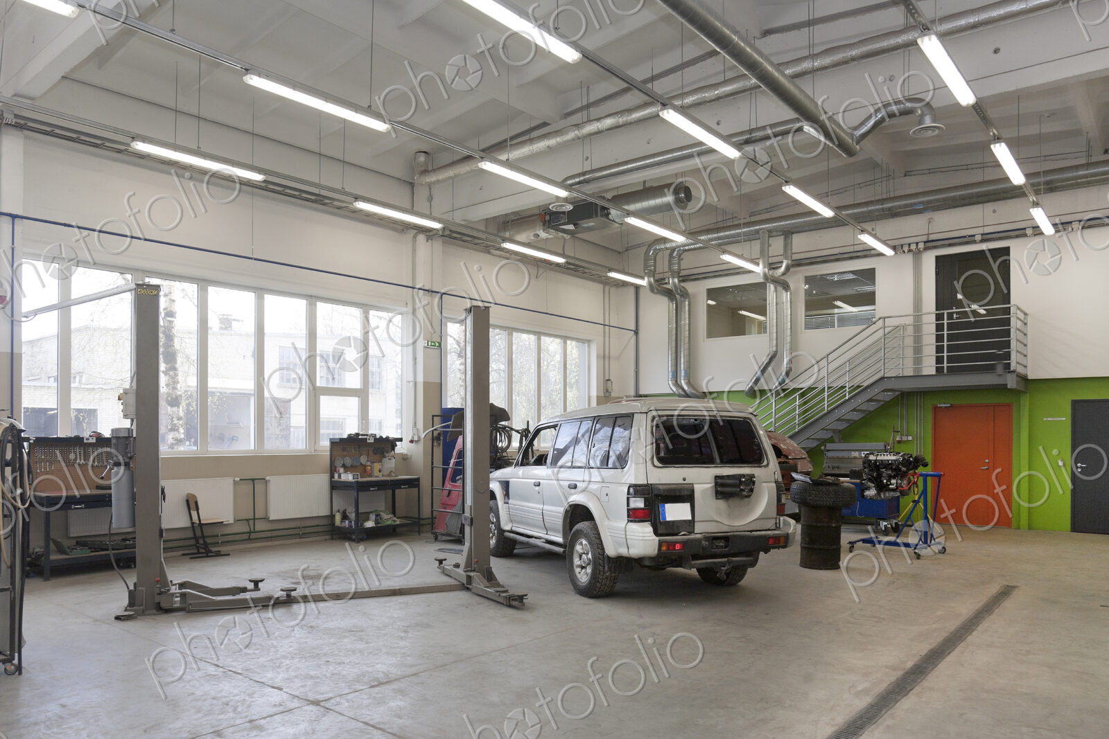SUV in a large repair workshop or garage.