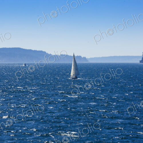 Sailboat on Puget Sound in windy conditions, near Seattle, WA USA Sailboat on Puget Sound in windy conditions, near Seattle, WA USA