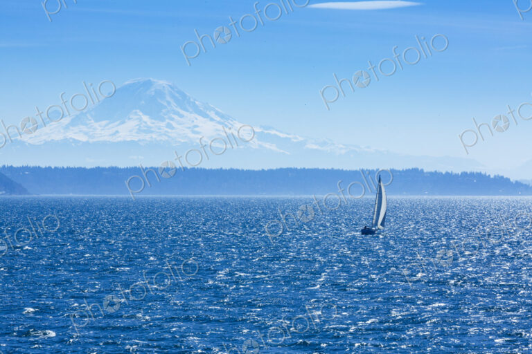 Sailboat on Puget Sound with view of Mt Rainier in windy conditions, near Seattle, WA USA