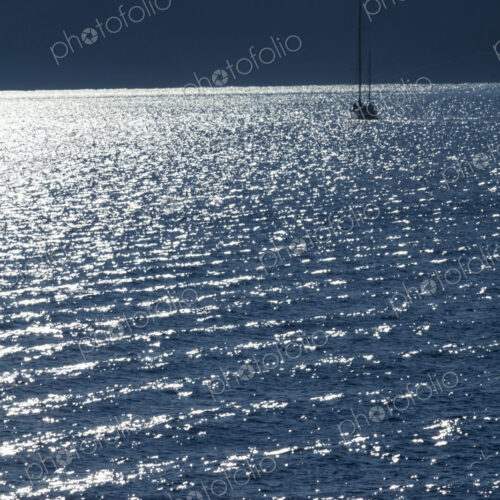 Sailboat on the water at dusk in Rosario Strait, around the San Juan Islands