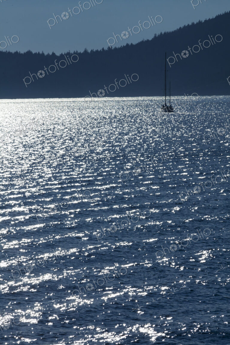 Sailboat on the water at dusk in Rosario Strait, around the San Juan Islands