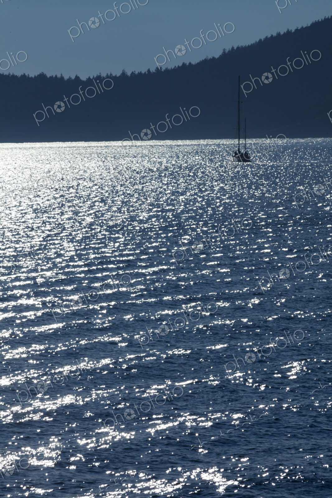 Sailboat on the water at dusk in Rosario Strait, around the San Juan Islands