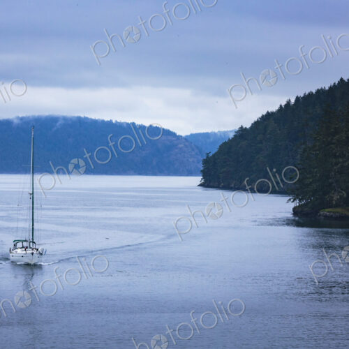 Sailboat on the water passing the islands in the San Juan straits. Sailboat on the water passing the islands in the San Juan straits.