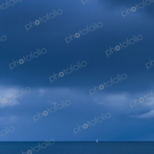 Sailboat onthe water by the horizon, Strait of Juan de Fuca. Sailboat onthe water by the horizon, Strait of Juan de Fuca.