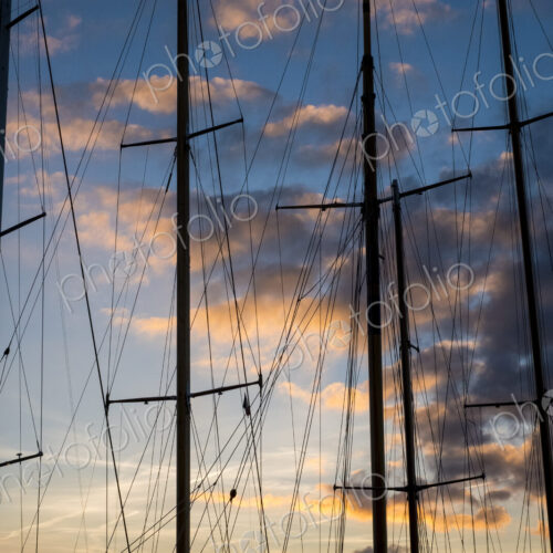 Sailing ship masts and rigging against a cloudy sky at sunset. Sailing ship masts and rigging against a cloudy sky at sunset.